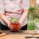 woman holding a flower pot, with two hands woman holding a flower pot, with two hands - PhotoDune Item for Sale