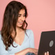 Young optimistic woman with laptop in studio. Young optimistic woman with laptop in studio. - PhotoDune Item for Sale