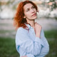 Redhead woman enjoying spring day outdoors Redhead woman enjoying spring day outdoors - PhotoDune Item for Sale