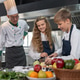 Student boy and girl study cooking in class at school kitchen. Asian ...
