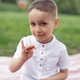 portrait of a four year old boy in a white shirt on a field in summer portrait of a four year old boy in a white shirt on a field in summer - PhotoDune Item for Sale
