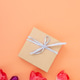 Gift box on peach background with colorful tulips decor Gift box on peach background with colorful tulips decor - PhotoDune Item for Sale