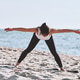 Woman practicing yoga exercise with wide arm stretch on Baltic Sea beach Woman practicing yoga exercise with wide arm stretch on Baltic Sea beach - PhotoDune Item for Sale