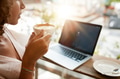 Woman drinking coffee with a laptop at restaurant Woman drinking coffee with a laptop at restaurant - PhotoDune Item for Sale