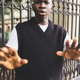 Black Man in Black Sweater Vest Gesture Near Ornate Fence with hand gesture NO or STOP Black Man in Black Sweater Vest Gesture Near Ornate Fence with hand gesture NO or STOP - PhotoDune Item for Sale