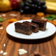 Chocolate cake bars served on a white plate in a restaurant setting. Chocolate cake bars served on a white plate in a restaurant setting. - PhotoDune Item for Sale