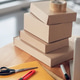 Packages stacked on a round wooden office desk Packages stacked on a round wooden office desk - PhotoDune Item for Sale
