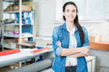 Smiling woman standing in printing office Smiling woman standing in printing office - PhotoDune Item for Sale