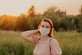 Redhead girl young woman wearing face mask outside during Coronavirus COVID-19 quarantine. Redhead girl young woman wearing face mask outside during Coronavirus COVID-19 quarantine. - PhotoDune Item for Sale