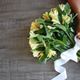 Woman’s hands, nails painted yellow tying bow on Yellow flowers flat lay Woman’s hands, nails painted yellow tying bow on Yellow flowers flat lay - PhotoDune Item for Sale