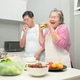 Asian senior couple preparing food together in the kitchen Asian senior couple preparing food together in the kitchen - PhotoDune Item for Sale