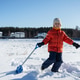 Child in winter clothes shoveling snow outdoors Child in winter clothes shoveling snow outdoors - PhotoDune Item for Sale