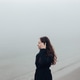 Woman on a foggy beach Woman on a foggy beach - PhotoDune Item for Sale