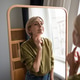Smiling beautiful middle aged woman standing checking makeup in mirror with positive expression. Smiling beautiful middle aged woman standing checking makeup in mirror with positive expression. - PhotoDune Item for Sale