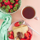 Crepes with chocolate spread and fresh strawberries, served with tea on pink background. Top view Crepes with chocolate spread and fresh strawberries, served with tea on pink background. Top view - PhotoDune Item for Sale
