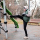 A man in a tracksuit and hat stretches with boxing gloves on an outdoor sports field. A man in a tracksuit and hat stretches with boxing gloves on an outdoor sports field. - PhotoDune Item for Sale