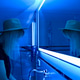 The girl in the hat washes her hands in the bathroom with neon lights. Pantone 2022 The girl in the hat washes her hands in the bathroom with neon lights. Pantone 2022 - PhotoDune Item for Sale