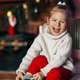 A beautiful little girl is smiling against the background of a Christmas room A beautiful little girl is smiling against the background of a Christmas room - PhotoDune Item for Sale
