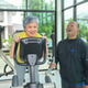 Senior couple exercising on a cardio machine in a gym Senior couple exercising on a cardio machine in a gym - PhotoDune Item for Sale