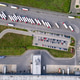 Top down aerial view of a logistics warehouse with loading docks, parked trucks and cars, showing or Top down aerial view of a logistics warehouse with loading docks, parked trucks and cars, showing or - PhotoDune Item for Sale