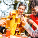 Young friends toasting beer pint at brewery garden venue Young friends toasting beer pint at brewery garden venue - PhotoDune Item for Sale