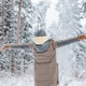 woman stands facing winter snowy forest with her hands out to sides Behind woman stands facing winter snowy forest with her hands out to sides Behind - PhotoDune Item for Sale
