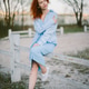 Woman with red hair sitting on fence enjoying spring Woman with red hair sitting on fence enjoying spring - PhotoDune Item for Sale