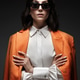 Spectacular beautiful woman in a trendy orange suit with classic make-up. Beauty face. Spectacular beautiful woman in a trendy orange suit with classic make-up. Beauty face. - PhotoDune Item for Sale