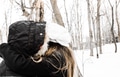 A millennial couple kisses under cover of parka hood on a snowy day A millennial couple kisses under cover of parka hood on a snowy day - PhotoDune Item for Sale