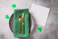 St Patrick's Day party table setting decorated with green leprechaun on wooden background. St Patrick's Day party table setting decorated with green leprechaun on wooden background. - PhotoDune Item for Sale