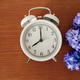 Alarm clock with hyacinth bouquet on wooden table Alarm clock with hyacinth bouquet on wooden table - PhotoDune Item for Sale