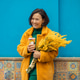 Young beautiful asian lady holding a branch of yellow flowers. She wearing bright clothes Young beautiful asian lady holding a branch of yellow flowers. She wearing bright clothes - PhotoDune Item for Sale