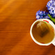 Hot cup of tea with hyacinth flowers on wood Hot cup of tea with hyacinth flowers on wood - PhotoDune Item for Sale