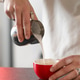 Barista pouring milk into freshly brewed coffee cup in cafe. Highlights smooth foam texture Barista pouring milk into freshly brewed coffee cup in cafe. Highlights smooth foam texture - PhotoDune Item for Sale