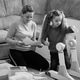 Mom and her daughter assemble a children's school table. The child helps his mother. Teamwork. Mom and her daughter assemble a children's school table. The child helps his mother. Teamwork. - PhotoDune Item for Sale