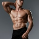 A Muscular Male Model captured in a Profile Pose with Dramatic HighContrast Lighting A Muscular Male Model captured in a Profile Pose with Dramatic HighContrast Lighting - PhotoDune Item for Sale