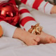 closeup of the bare feet of a child in red and white pajamas lying in bed on a white sheet closeup of the bare feet of a child in red and white pajamas lying in bed on a white sheet - PhotoDune Item for Sale