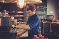 Barista preparing cup of coffee for customer in coffee shop. Barista preparing cup of coffee for customer in coffee shop. - PhotoDune Item for Sale