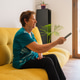 Older woman using the television remote control Older woman using the television remote control - PhotoDune Item for Sale