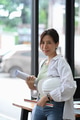 Beautiful engineer woman holding helmet and looking at camera while standing in office. Beautiful engineer woman holding helmet and looking at camera while standing in office. - PhotoDune Item for Sale