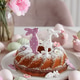 Traditional easter cakes with icing decorated with gingerbread cookies in shape of rabbits Traditional easter cakes with icing decorated with gingerbread cookies in shape of rabbits - PhotoDune Item for Sale