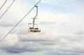 Empty chairlift with cloudy sky in the background Empty chairlift with cloudy sky in the background - PhotoDune Item for Sale