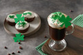 Irish coffee in green cup and special cupcakes for St Patrick's Day. Close up. Irish coffee in green cup and special cupcakes for St Patrick's Day. Close up. - PhotoDune Item for Sale