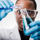 african american scientist in lab working with test tubes and beakers african american scientist in lab working with test tubes and beakers - PhotoDune Item for Sale