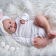 Newborn baby in a white Easter bunny costume on a white cozy blanket, white eggs lie nearby Newborn baby in a white Easter bunny costume on a white cozy blanket, white eggs lie nearby - PhotoDune Item for Sale