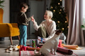 Mother with son are wrapping Christmas gifts at home on a floor. Mother with son are wrapping Christmas gifts at home on a floor. - PhotoDune Item for Sale
