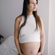 Portrait of beautiful pregnant Caucasian brunette with long hair in gynecology office Portrait of beautiful pregnant Caucasian brunette with long hair in gynecology office - PhotoDune Item for Sale