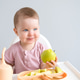 cute baby eating apple sitting in a baby chair. weaning cute baby eating apple sitting in a baby chair. weaning - PhotoDune Item for Sale