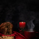 pannetonw with tea and a candle in the far right on a black concrete background pannetonw with tea and a candle in the far right on a black concrete background - PhotoDune Item for Sale