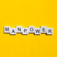 Manpower scrabble letters word on a yellow background Stock Photo by ...
